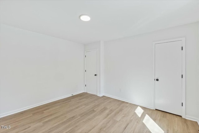 spare room with light hardwood / wood-style flooring