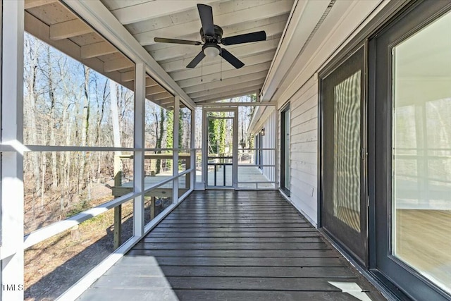 wooden terrace with ceiling fan and covered porch