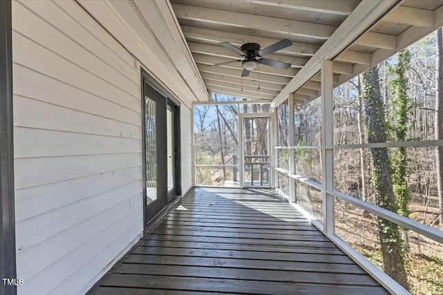 unfurnished sunroom with beam ceiling and ceiling fan