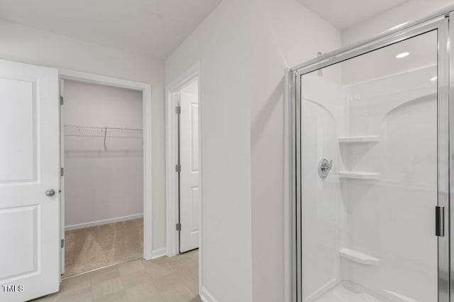 bathroom with a shower with door