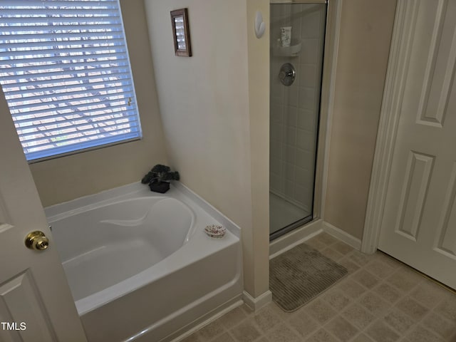 bathroom with tile patterned floors and separate shower and tub