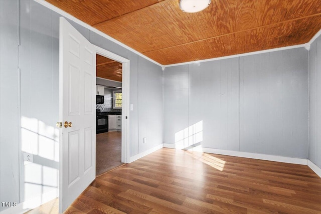 empty room featuring crown molding, wooden ceiling, and dark hardwood / wood-style floors