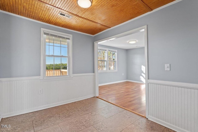 empty room with wood ceiling and ornamental molding