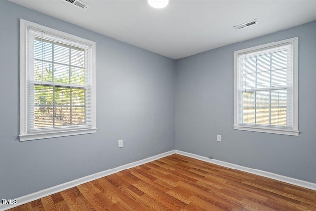 spare room with hardwood / wood-style flooring