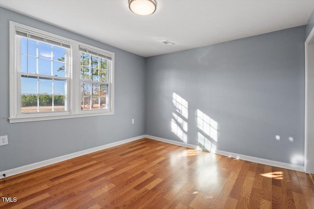 unfurnished room with wood-type flooring