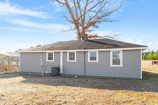 back of property featuring a yard and central AC unit