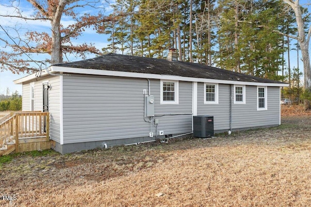 view of property exterior featuring cooling unit and a lawn