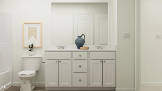 bathroom featuring vanity, a bathtub, and toilet