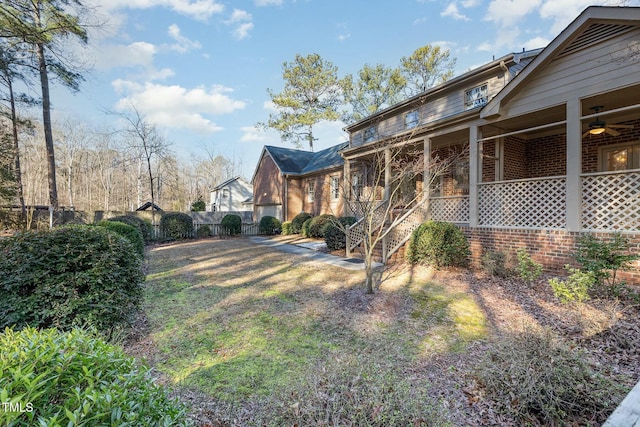 view of yard with ceiling fan