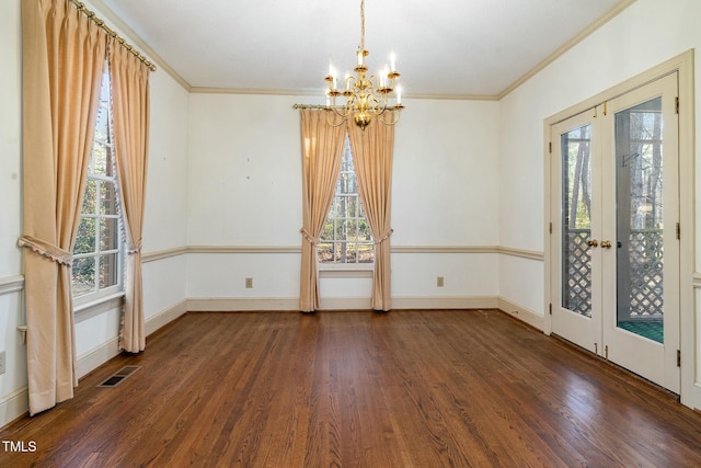 unfurnished dining area featuring ornamental molding, plenty of natural light, dark hardwood / wood-style floors, and french doors