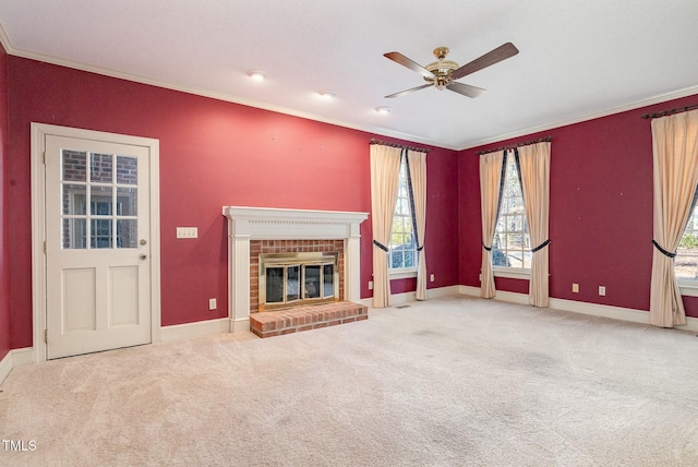 unfurnished living room with a brick fireplace, crown molding, and carpet