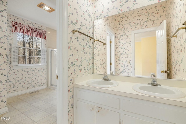 bathroom featuring tile patterned flooring, vanity, and a shower with shower door