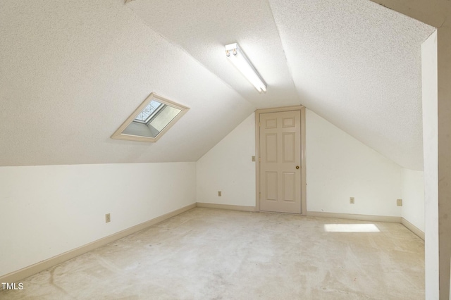 additional living space with light carpet, vaulted ceiling, and a textured ceiling