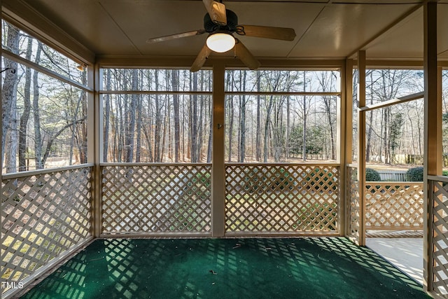 unfurnished sunroom featuring ceiling fan