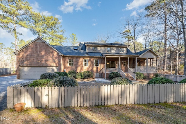 view of front facade featuring a porch and a garage