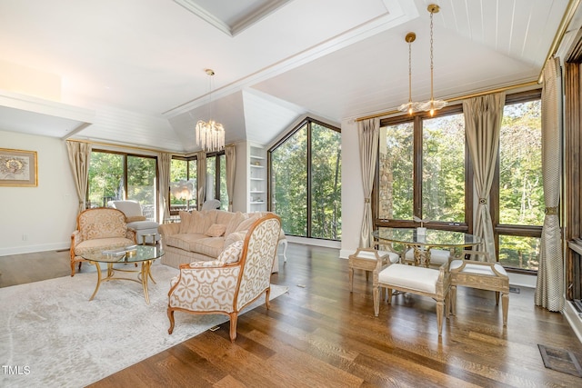 sunroom with plenty of natural light and a notable chandelier