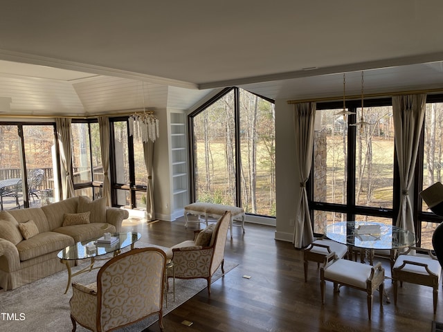 sunroom / solarium with an inviting chandelier