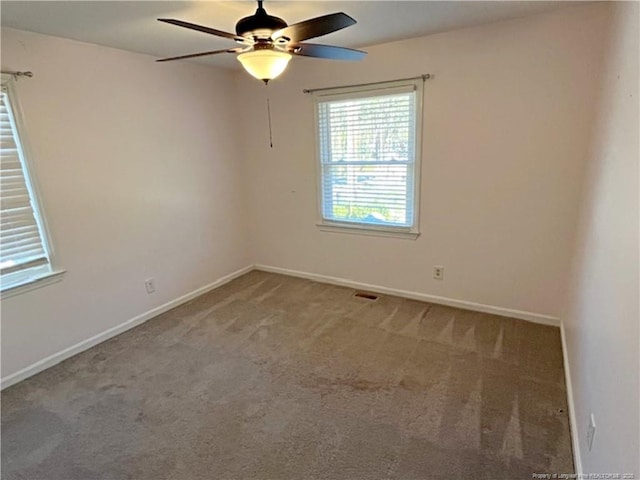 empty room featuring carpet and ceiling fan