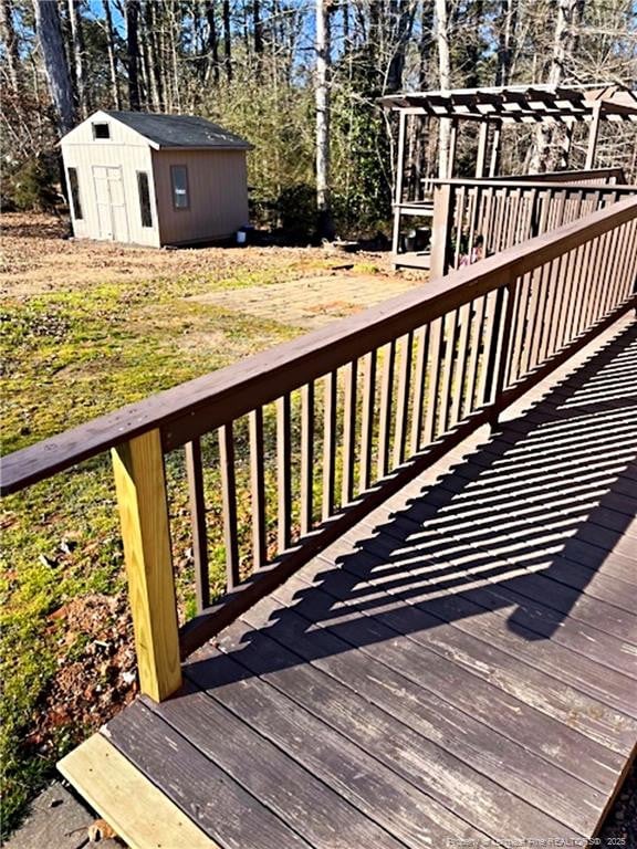 wooden terrace featuring a storage unit