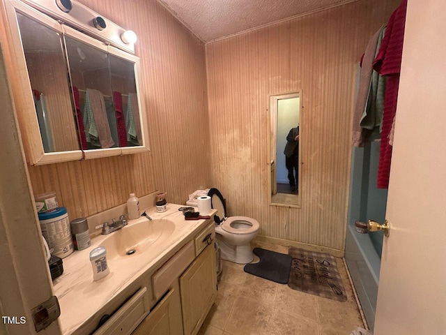 bathroom with a bathing tub, tile patterned flooring, vanity, toilet, and a textured ceiling