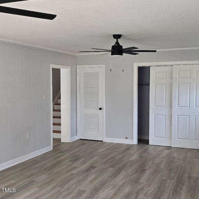 unfurnished bedroom with crown molding, ceiling fan, hardwood / wood-style flooring, and a textured ceiling