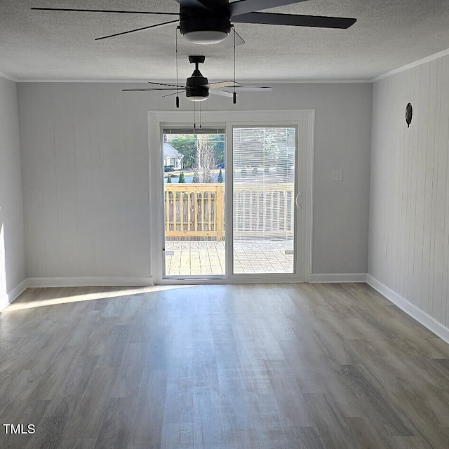 spare room with wood-type flooring, a textured ceiling, ceiling fan, and crown molding