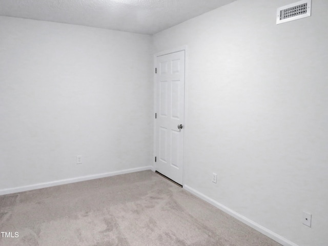 130 Luxon Pl, Cary, NC 27513 - empty room with light colored carpet, visible vents, baseboards, and a textured ceiling