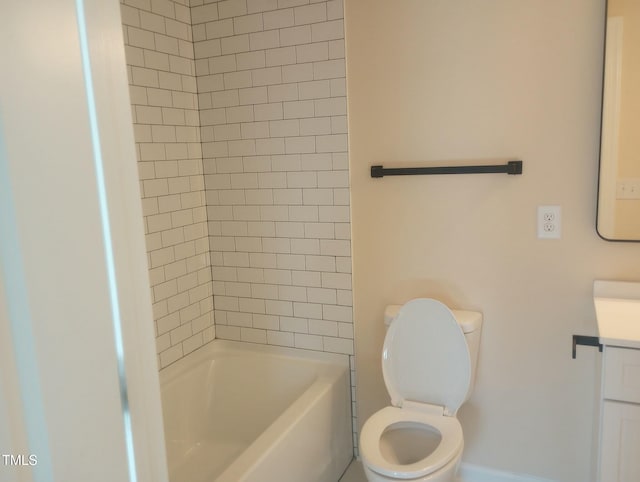 full bathroom featuring tiled shower / bath, vanity, and toilet