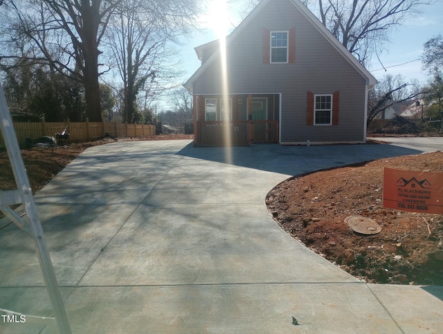 view of front of house featuring fence