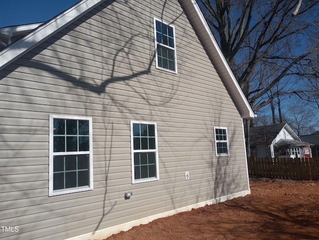 view of property exterior featuring fence