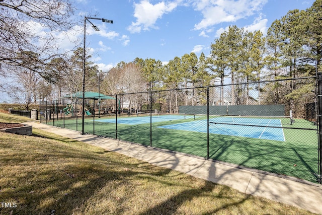 view of sport court with a playground