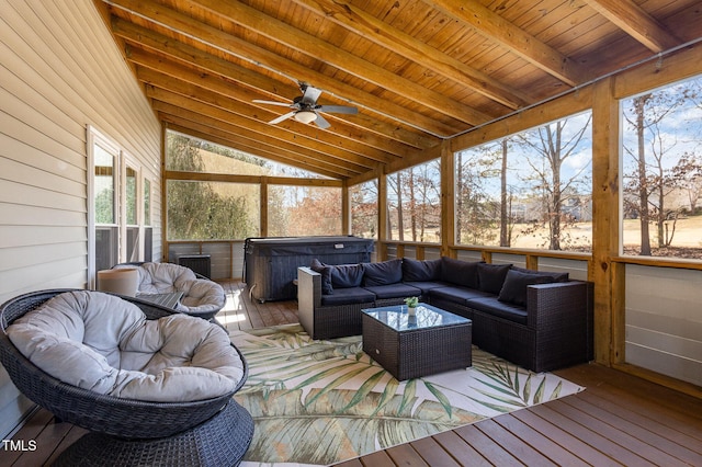 sunroom / solarium with lofted ceiling with beams, wooden ceiling, and ceiling fan