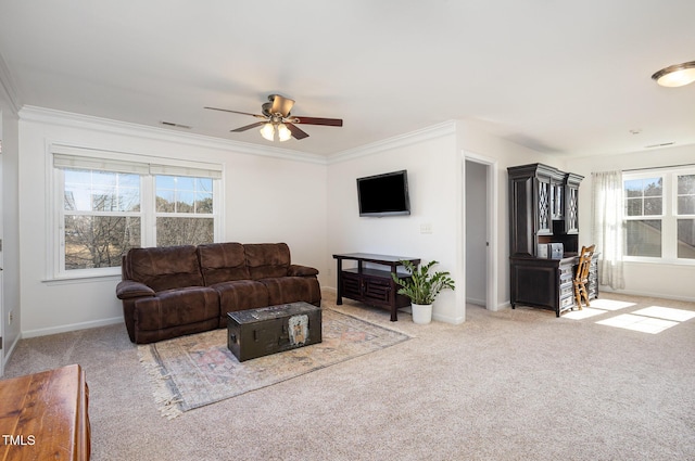 living room with crown molding, ceiling fan, and light carpet