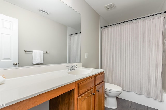 bathroom featuring toilet, vanity, visible vents, and tile patterned floors