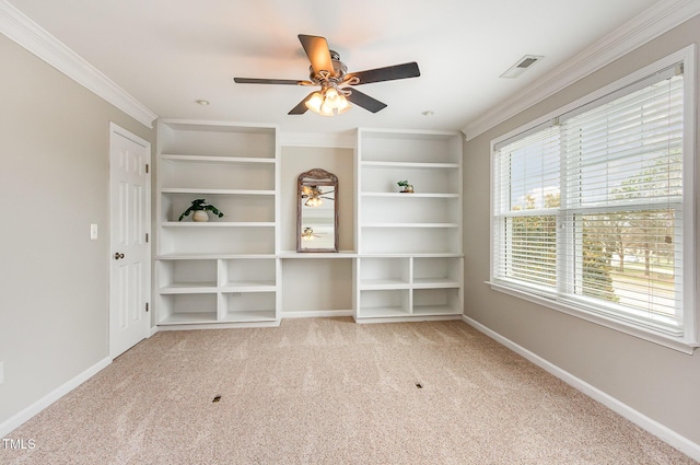 spare room featuring baseboards, visible vents, a ceiling fan, ornamental molding, and carpet