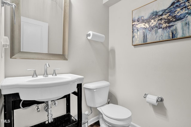 bathroom featuring sink and toilet