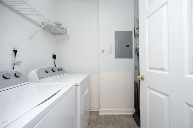 laundry room featuring light tile patterned floors, laundry area, baseboards, washer and dryer, and electric panel