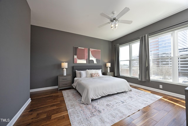 bedroom featuring dark wood-style flooring, ceiling fan, and baseboards