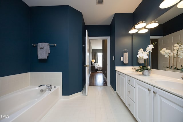 full bathroom with double vanity, visible vents, ensuite bathroom, tile patterned floors, and a sink