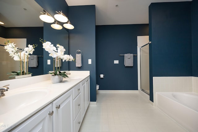 bathroom with toilet, a sink, tile patterned flooring, baseboards, and a bath