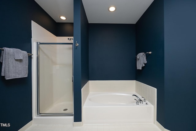 full bath with a stall shower, recessed lighting, a bath, and tile patterned floors