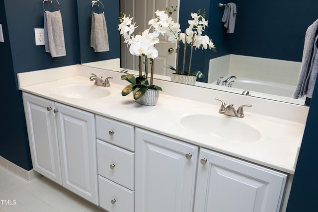 bathroom featuring double vanity, a sink, and tile patterned floors