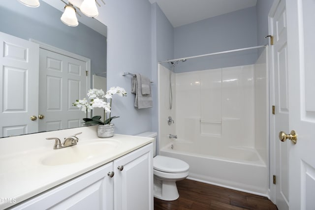 full bathroom with toilet,  shower combination, wood finished floors, and vanity