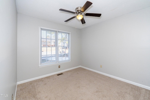 unfurnished room with light colored carpet and ceiling fan