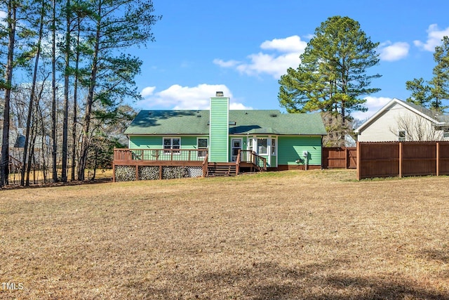 back of house with a wooden deck and a yard