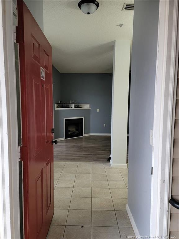 hallway featuring light tile patterned flooring