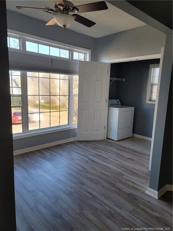 interior space with washer / dryer, hardwood / wood-style floors, and ceiling fan