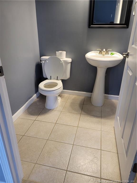 bathroom featuring tile patterned flooring and toilet