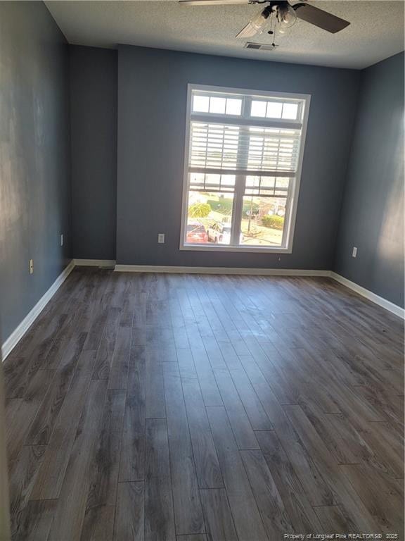 unfurnished room with dark hardwood / wood-style flooring, a textured ceiling, and ceiling fan