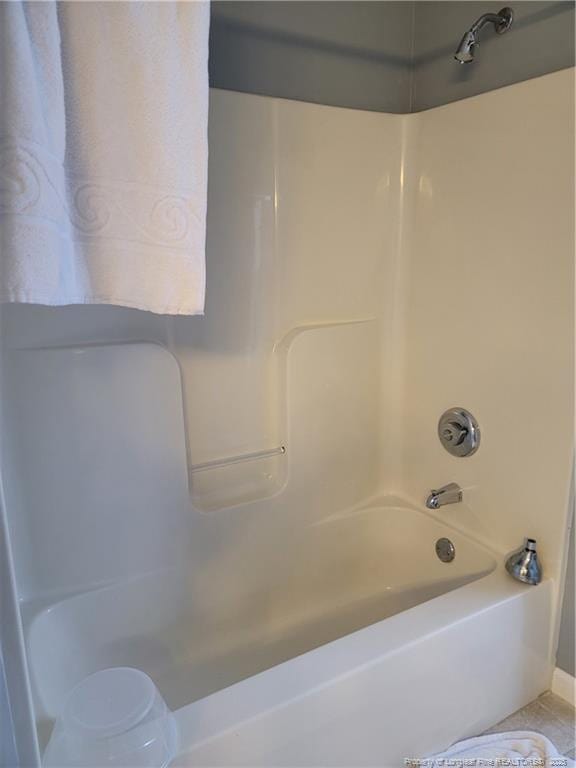 bathroom with shower / washtub combination